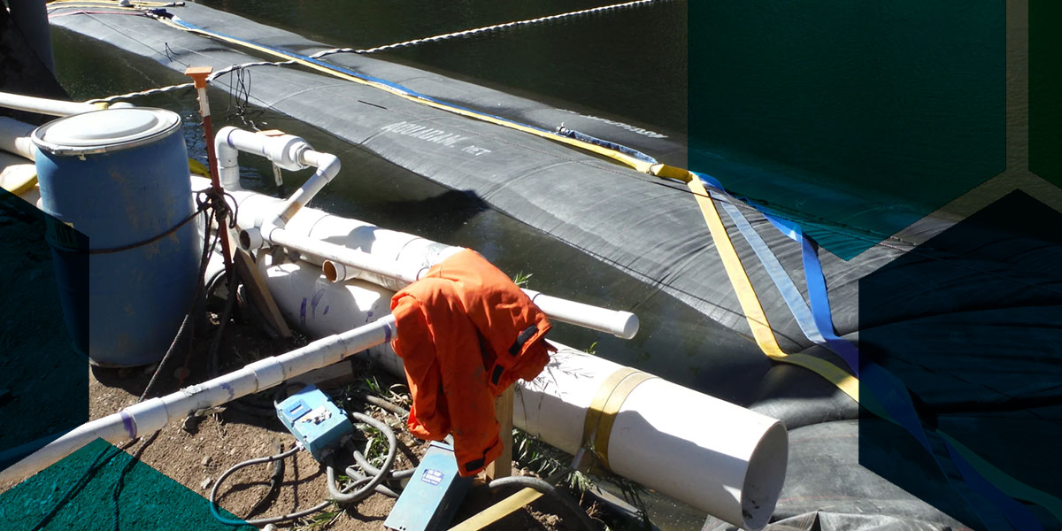 A rapid deployment flood barrier in action by AquaDam.