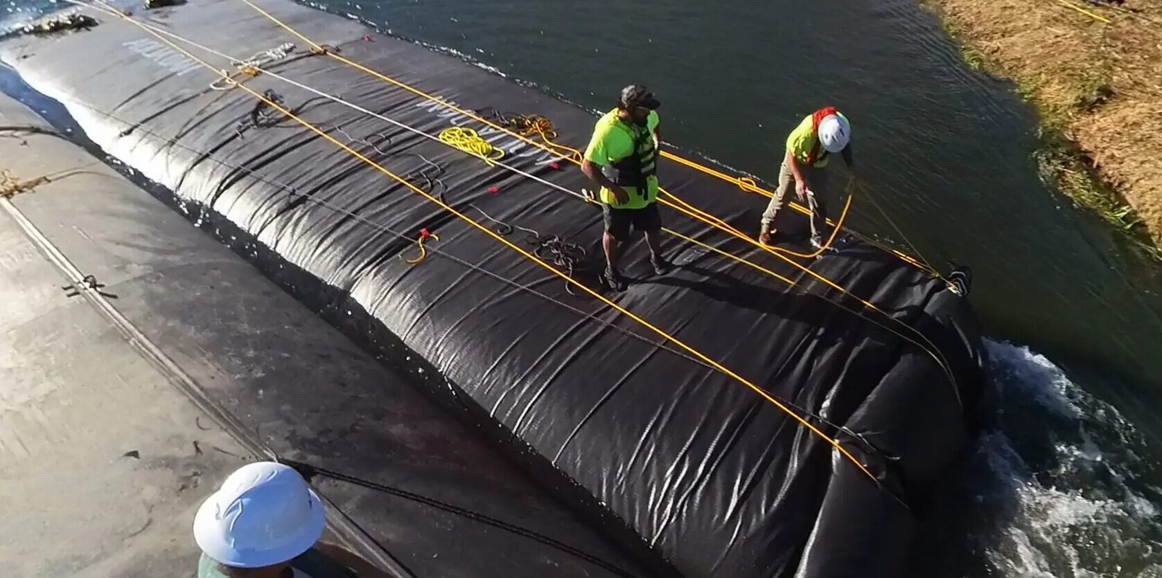 Aqua Dam responding to an emergency flood barrier with staff and deployment of an AquaDam.